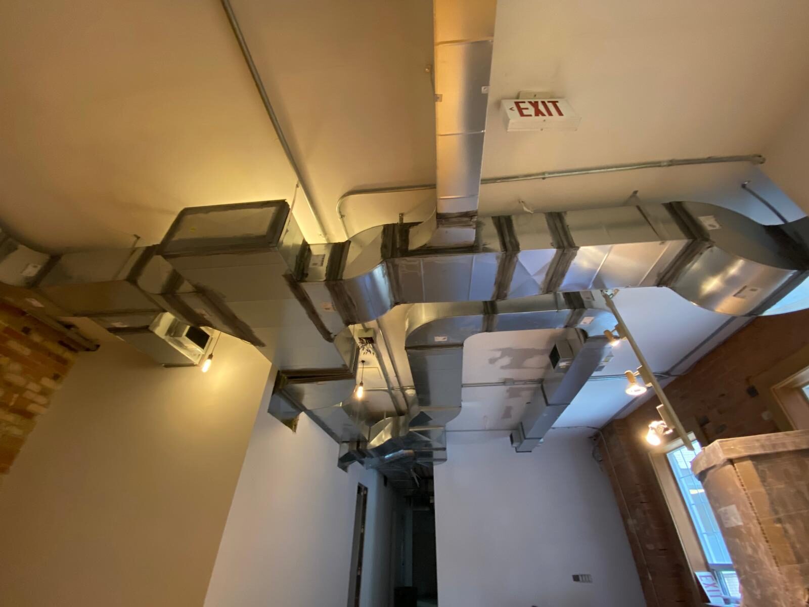 Exposed rectangular ductwork in a finished commercial ceiling